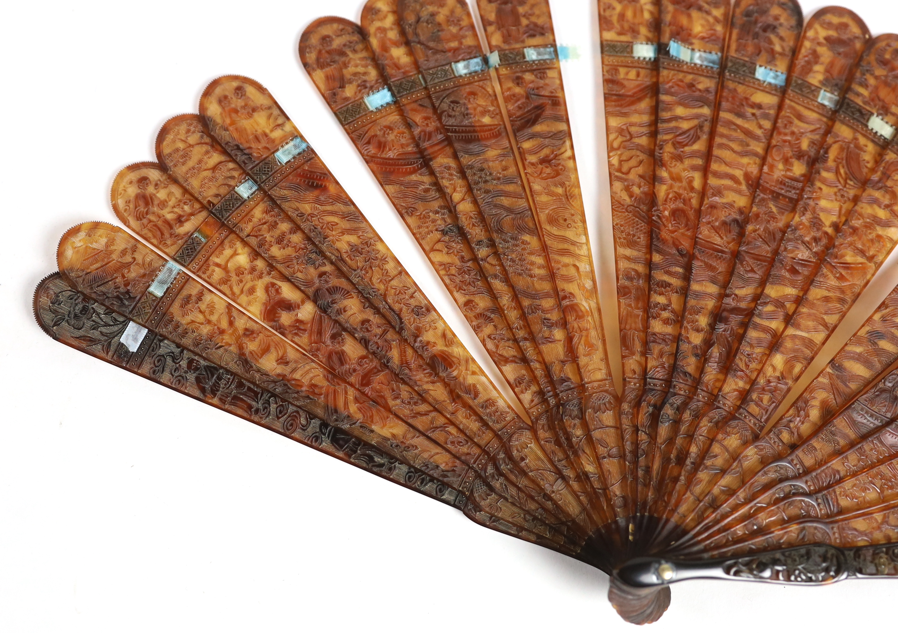 A 19th century Chinese finely carved tortoiseshell brisé fan, 18cm high